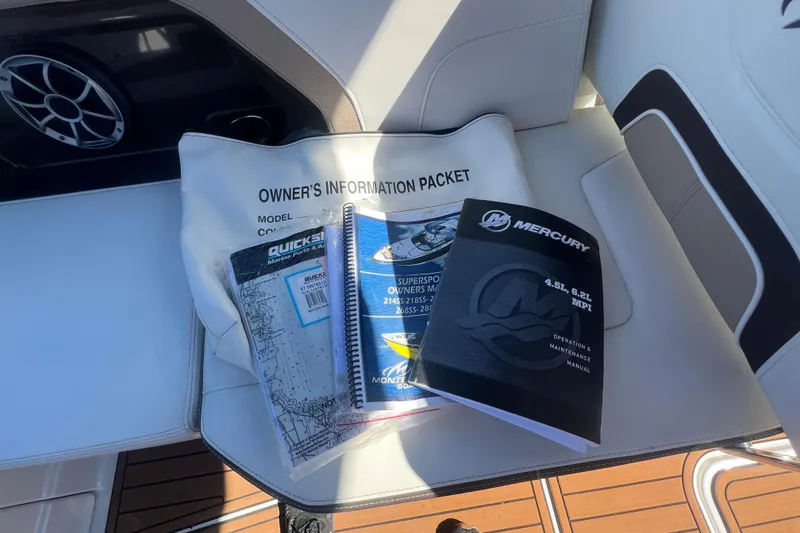 Slide: The Image of Owner's manuals and information packet for 2017 Monterey 298SS Super Sport on boat seat. - 45