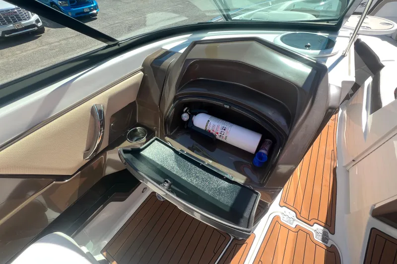 Slide: The Image of 2017 Monterey 298SS Super Sport boat interior with storage compartment and fire extinguisher. - 46
