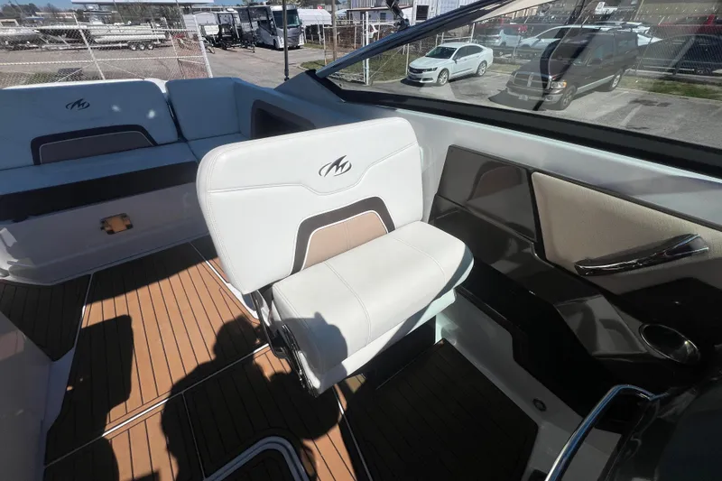Slide: The Image of 2017 Monterey 298SS Super Sport boat interior with white seating and wood flooring. - 49