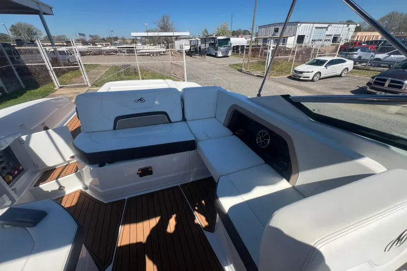 Slide: The Image of 2017 Monterey 298SS Super Sport boat interior with white seating and wood flooring. - 50