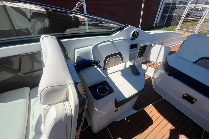 Slide: The Image of Interior of a 2017 Monterey 298SS Super Sport boat with white seating and wood flooring. - 51