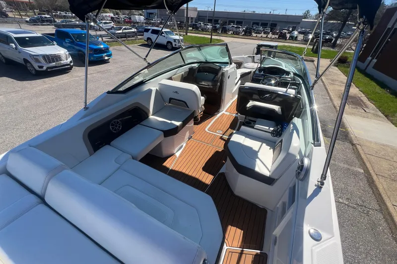 Slide: The Image of 2017 Monterey 298SS Super Sport boat with spacious seating and sleek design in a parking lot. - 63