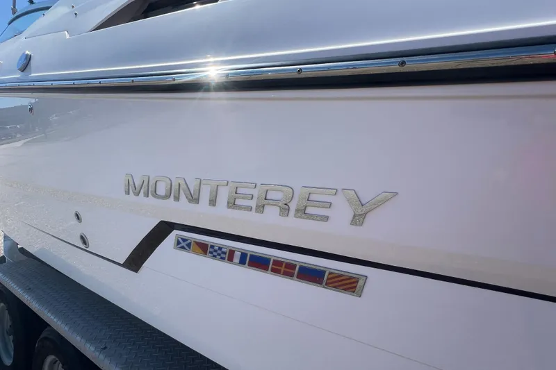 Slide: The Image of 2017 Monterey 298SS Super Sport boat with nautical flags and sleek design. - 7