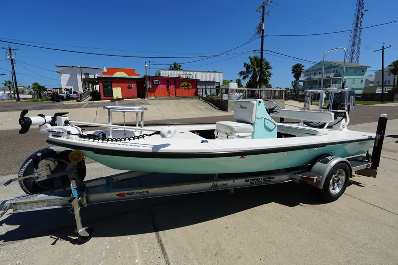 The Image of 2014 Maverick 17 HPX Tunnel boat on trailer, parked in urban setting under clear blue sky. - 0