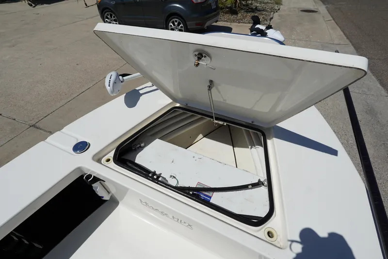 Slide: The Image of Open storage compartment on a 2014 Maverick 17 HPX Tunnel boat, parked outdoors. - 11