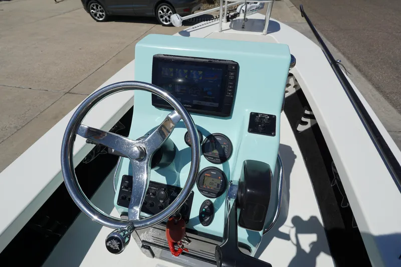 Slide: The Image of 2014 Maverick 17 HPX Tunnel boat dashboard with steering wheel and navigation system. - 12
