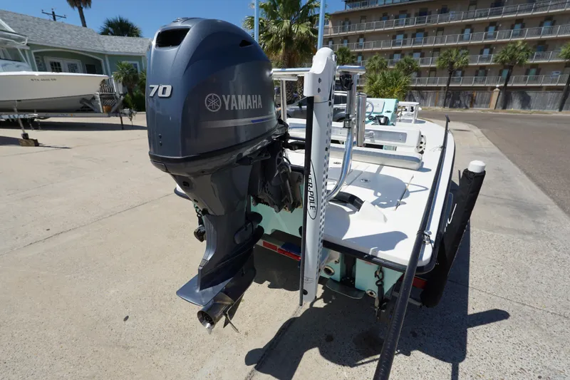 Slide: The Image of 2014 Maverick 17 HPX Tunnel boat with Yamaha 70 engine, parked outdoors. - 5
