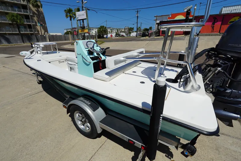 Slide: The Image of 2014 Maverick 17 HPX Tunnel boat on trailer, parked outdoors in sunny setting. - 7