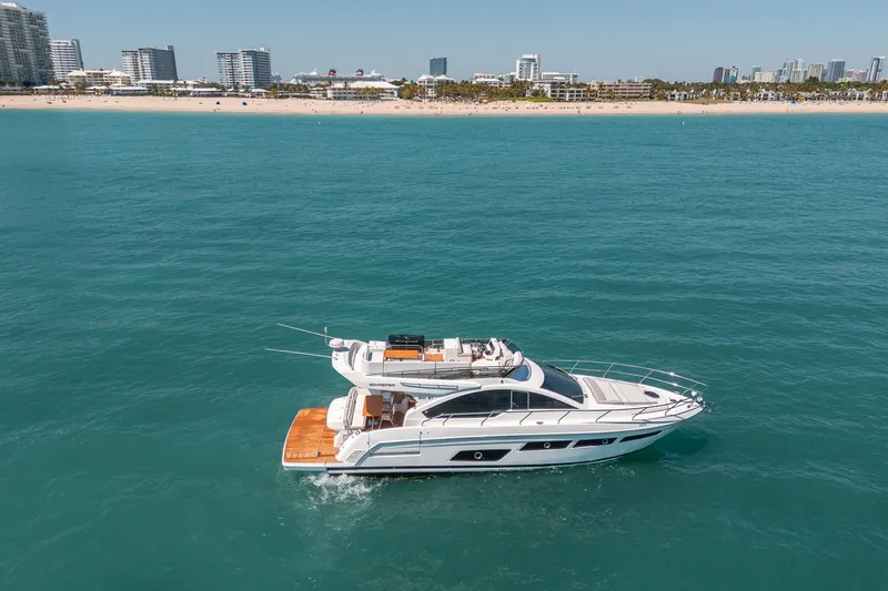 Slide: The Image of Luxury yacht Schaefer 510 GT 2023 near coast with city view. - 15