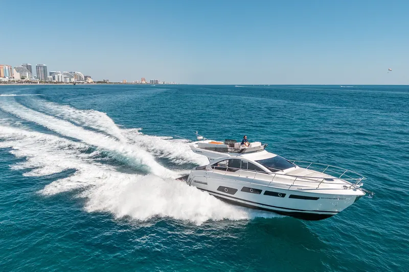 Slide: The Image of Schaefer 510 GT Yacht 2023 cruising on open sea near coastal city. - 27