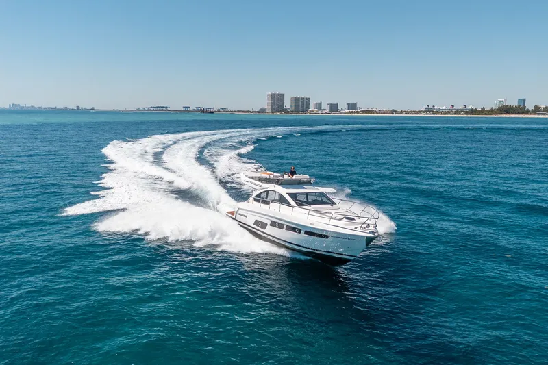 Slide: The Image of Schaefer 510 GT 2023 yacht cruising on open sea under clear sky. - 30