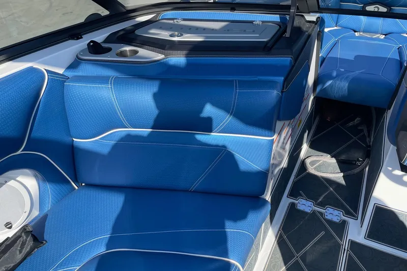 Slide: The Image of 2022 Centurion Ri230 boat interior with blue seating and modern design. - 5