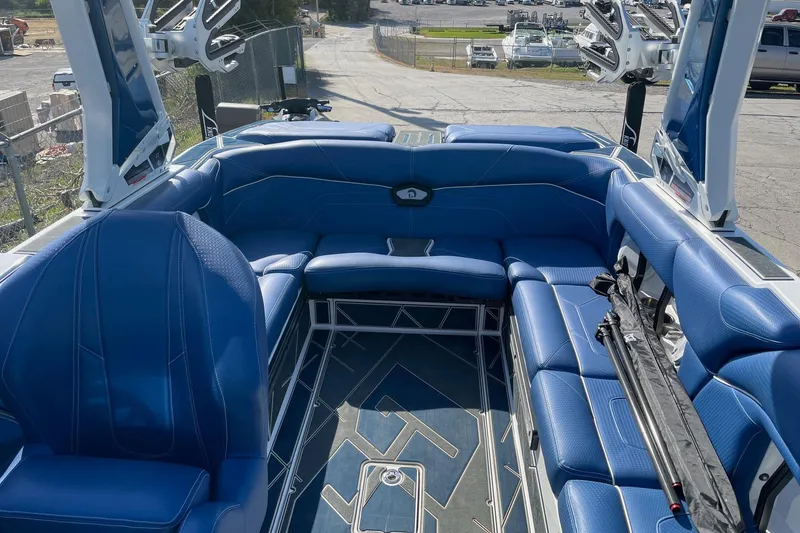 Slide: The Image of 2022 Centurion Ri230 boat interior with blue seating and sleek design. - 6