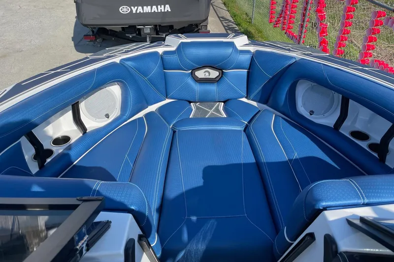 Slide: The Image of 2022 Centurion Ri230 boat interior with blue seating and white accents. - 7