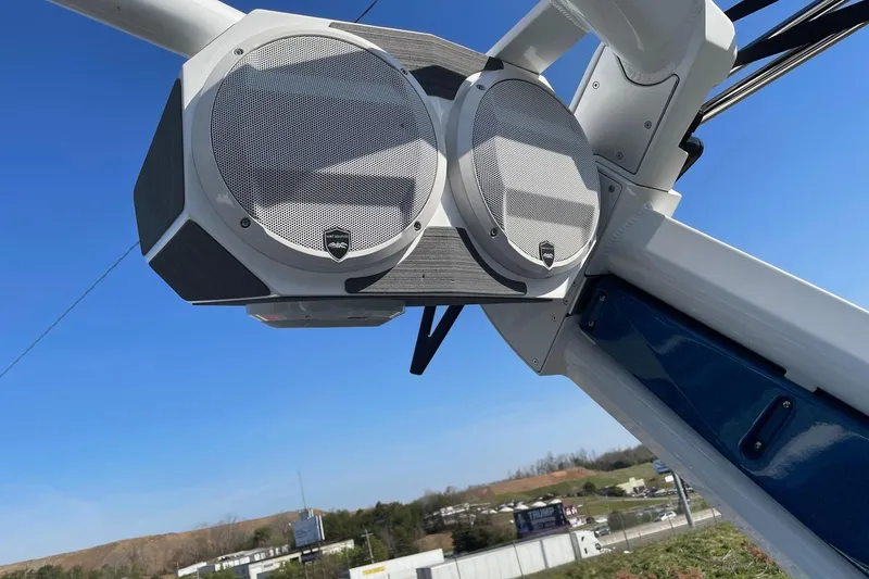 Slide: The Image of Centurion Ri230 2022 boat speakers mounted on a tower against a clear blue sky. - 8