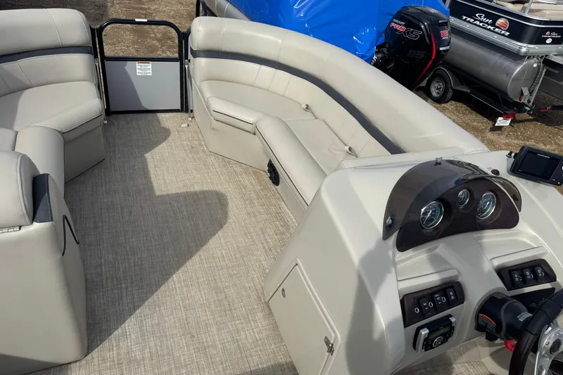 Slide: The Image of 2018 South Bay 200 pontoon boat interior with beige seating and control panel. - 5