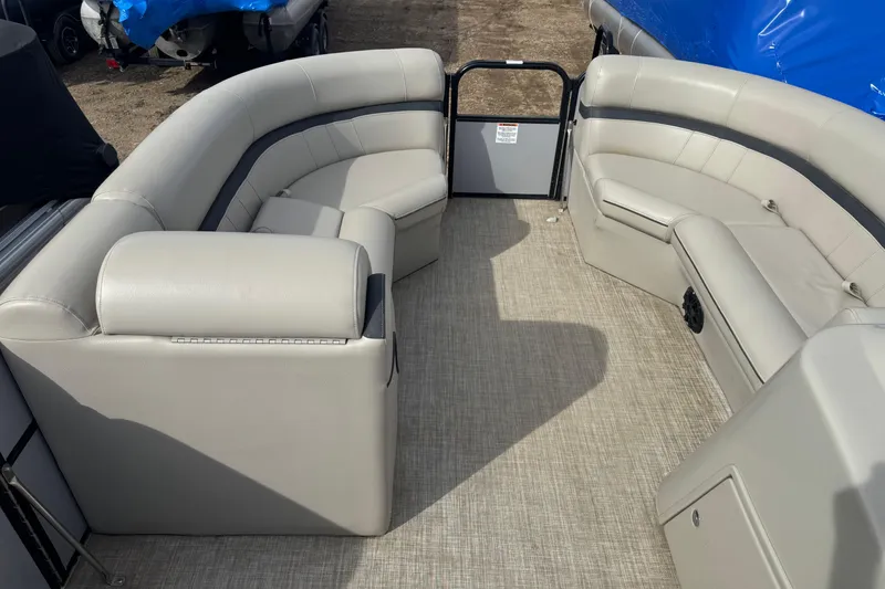 Slide: The Image of 2018 South Bay 200 pontoon boat interior with beige seating and carpeted floor. - 6
