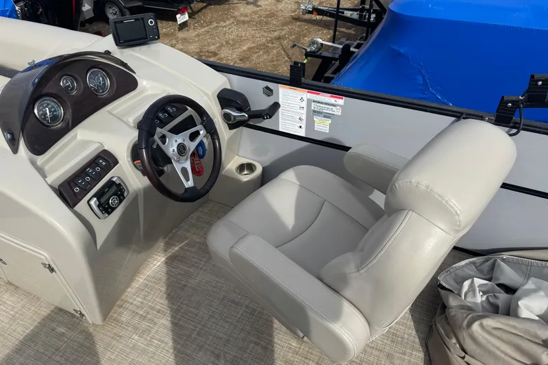 Slide: The Image of Captain's chair and dashboard of a 2018 South Bay 200 boat, featuring steering wheel and controls. - 7