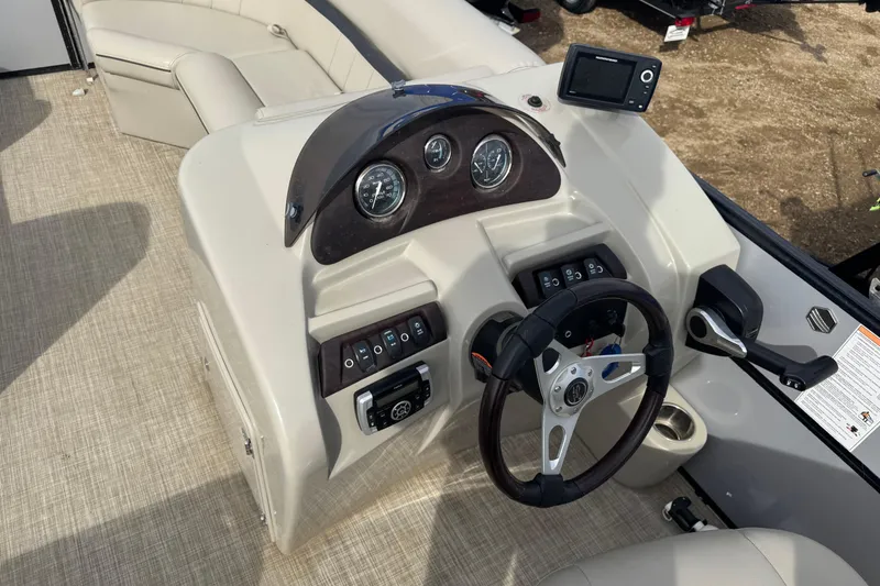 Slide: The Image of Cockpit of 2018 South Bay 200 boat with steering wheel and control panel. - 8