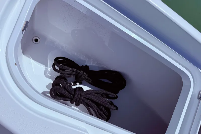 Slide: The Image of Storage compartment with ropes on a 2014 Yellowfin 24 Bay boat. - 13