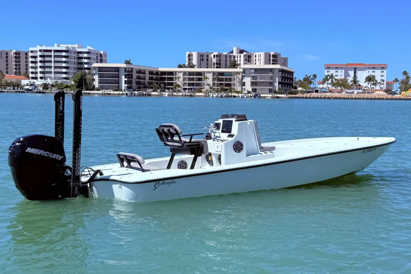 Slide: The Image of 2014 Yellowfin 24 Bay boat on water with cityscape background. - 5