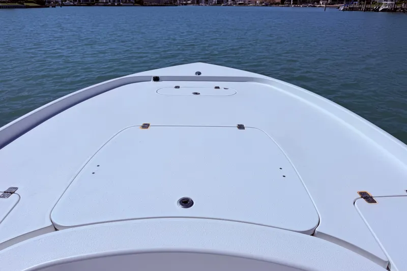 Slide: The Image of Bow of a 2014 Yellowfin 24 Bay boat on calm water. - 8