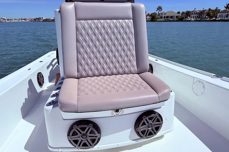 Slide: The Image of 2014 Yellowfin 24 Bay boat seat with diamond-stitched upholstery on calm water. - 9