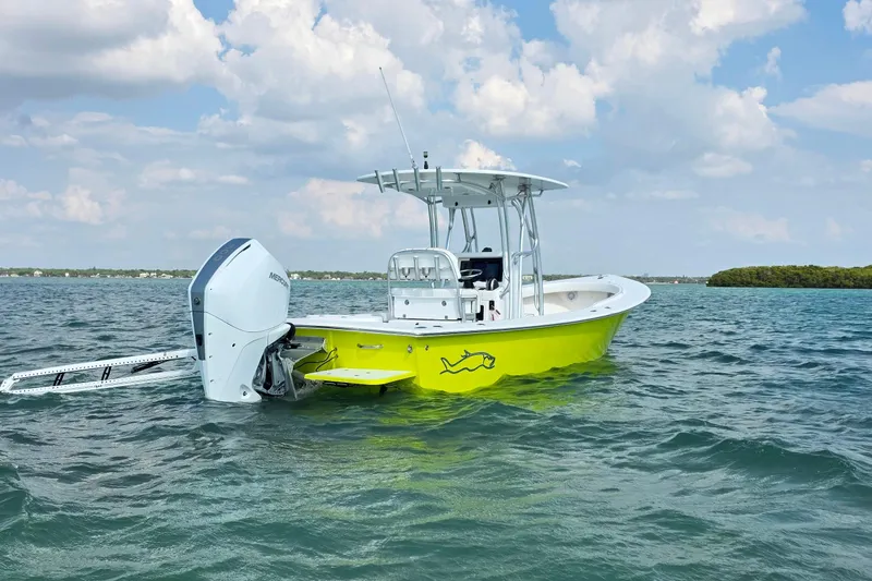 Slide: The Image of 2012 Gause Built 26 Center Console boat on water, vibrant yellow hull, clear sky background. - 10