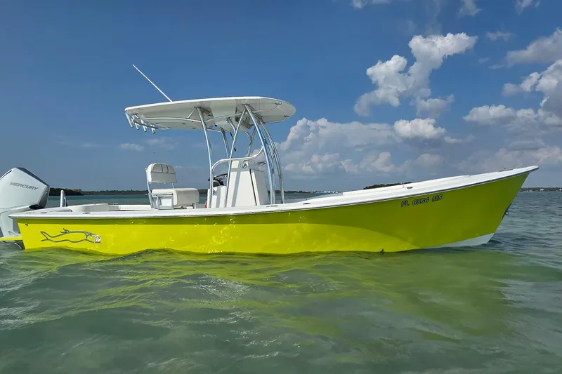 Slide: The Image of 2012 Gause Built 26 Center Console boat with vibrant yellow hull on calm water. - 11