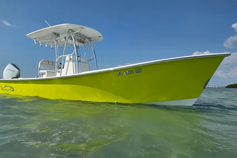 Slide: The Image of 2012 Gause Built 26 Center Console boat in vibrant yellow on clear water. - 12