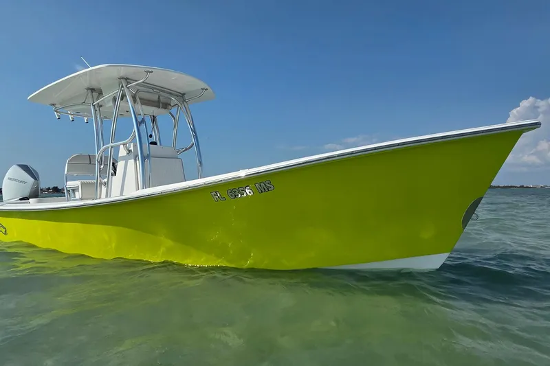 Slide: The Image of 2012 Gause Built 26 Center Console boat in vibrant yellow on clear water. - 13