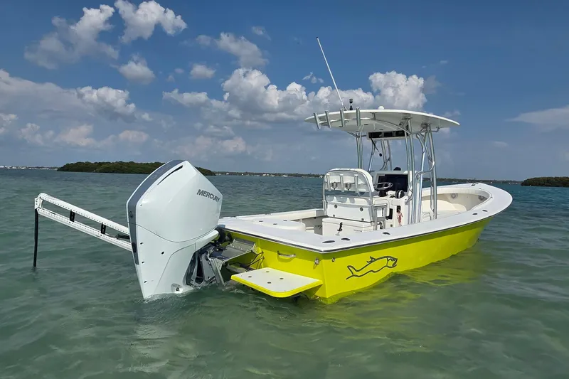 Slide: The Image of 2012 Gause Built 26 Center Console boat in vibrant yellow on calm water. - 16