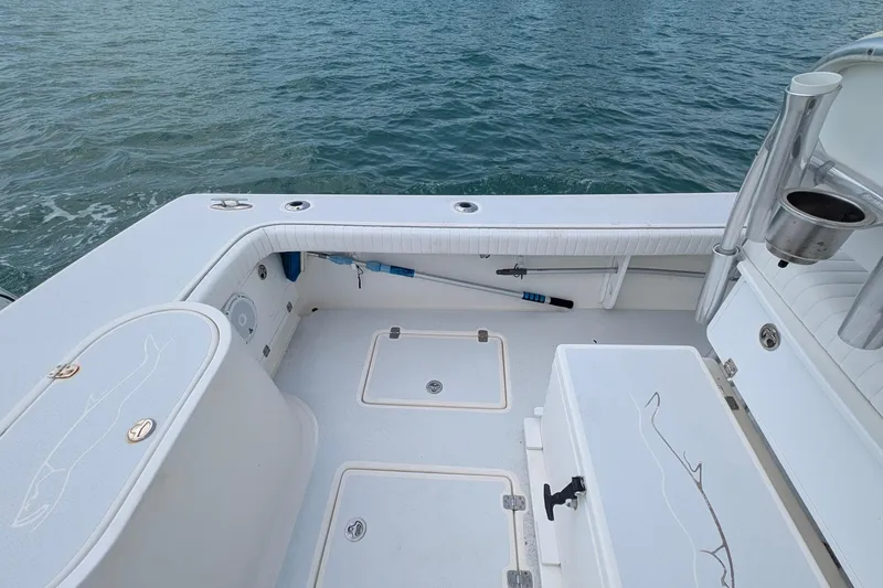 Slide: The Image of 2012 Gause Built 26 Center Console boat interior with storage compartments and rod holders. - 18