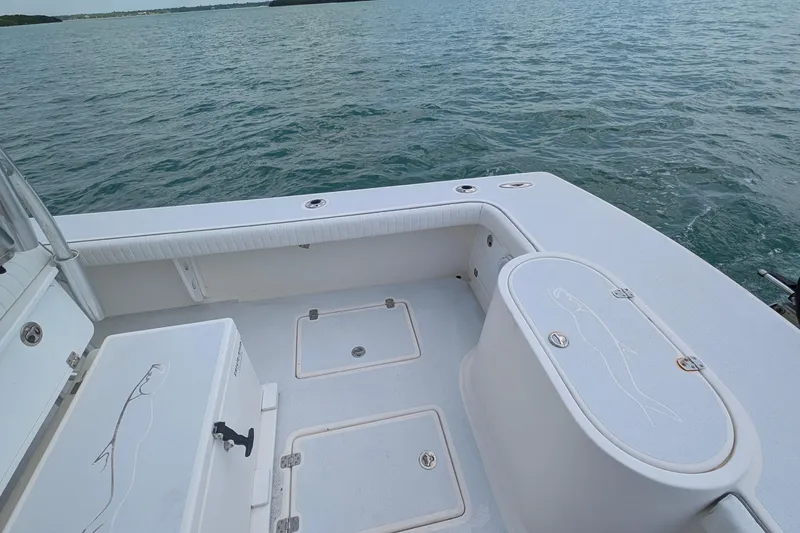 Slide: The Image of 2012 Gause Built 26 Center Console boat on water, featuring spacious deck and storage compartments. - 19
