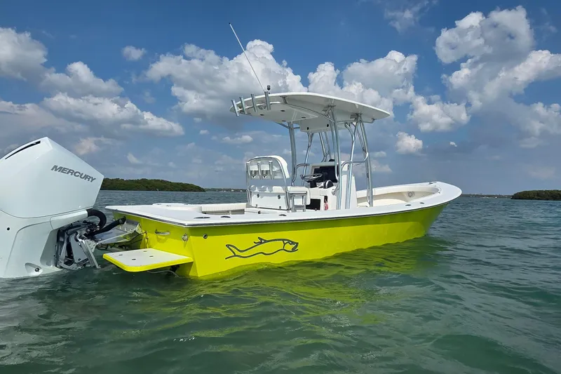 Slide: The Image of 2012 Gause Built 26 Center Console boat on water, featuring a vibrant yellow hull. - 2