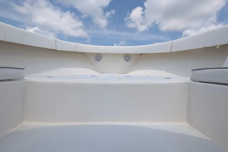 Slide: The Image of 2012 Gause Built 26 Center Console boat interior with speakers, under a blue sky. - 25