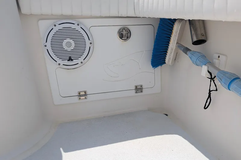 Slide: The Image of 2012 Gause Built 26 Center Console boat interior with speaker and cleaning brush. - 33