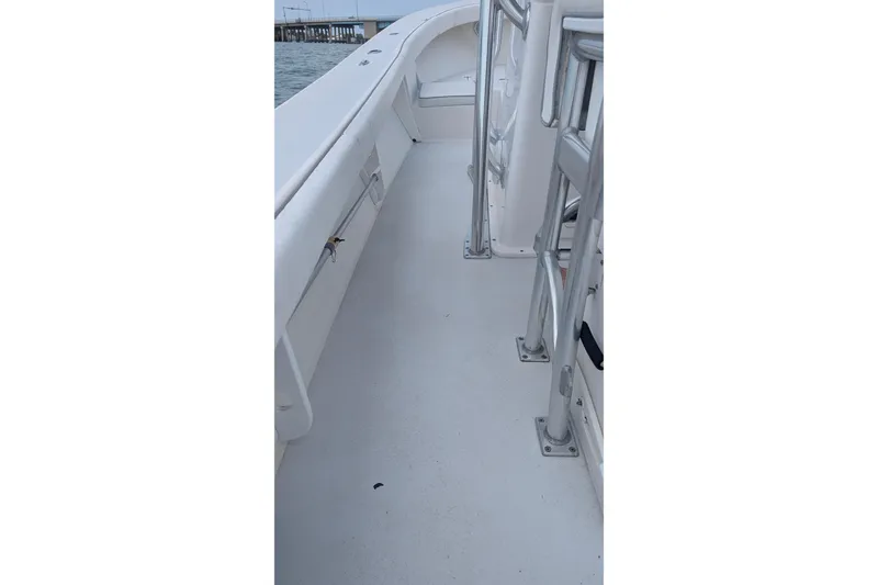 Slide: The Image of 2012 Gause Built 26 Center Console boat deck with railing, dock in background. - 37