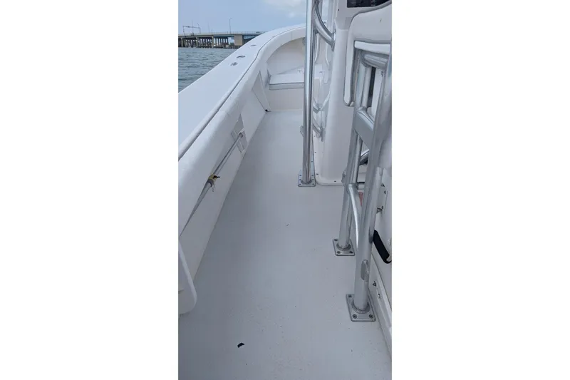 Slide: The Image of 2012 Gause Built 26 Center Console boat deck with railing, near water and bridge. - 38
