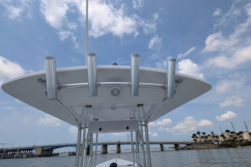 Slide: The Image of 2012 Gause Built 26 Center Console boat with T-top, under a blue sky near a bridge. - 39