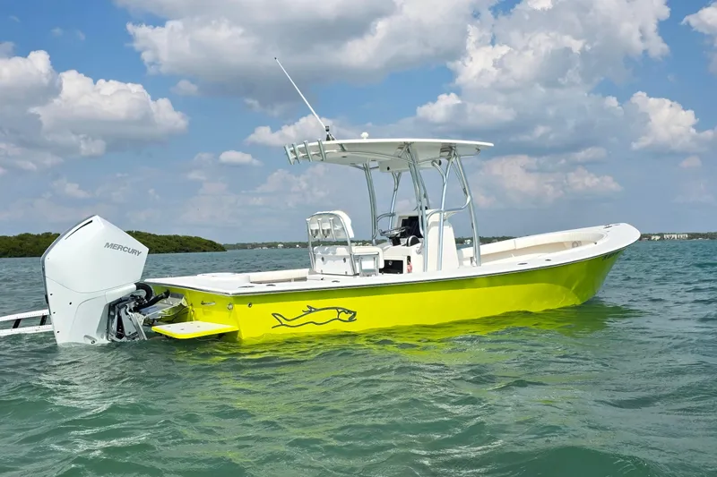 Slide: The Image of 2012 Gause Built 26 Center Console boat on water, bright yellow hull, Mercury engine. - 4
