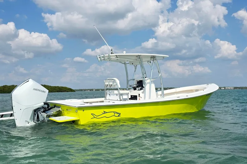 Slide: The Image of 2012 Gause Built 26 Center Console boat on water, vibrant yellow hull, Mercury engine. - 5