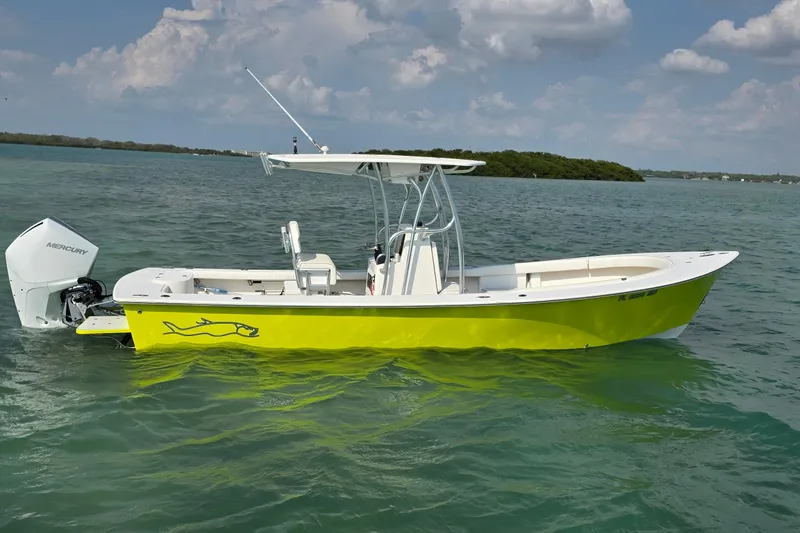 Slide: The Image of 2012 Gause Built 26 Center Console boat on water, vibrant yellow hull, Mercury engine. - 6