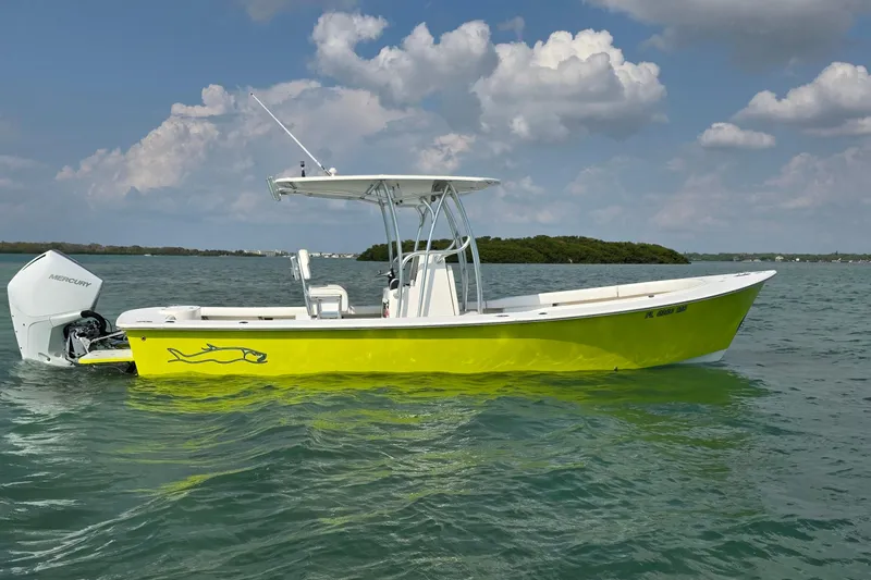 Slide: The Image of 2012 Gause Built 26 Center Console boat on water, vibrant yellow hull, Mercury engine. - 7