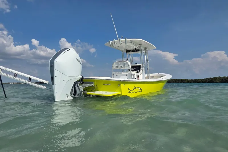 Slide: The Image of 2012 Gause Built 26 Center Console boat in vibrant yellow on calm water. - 8