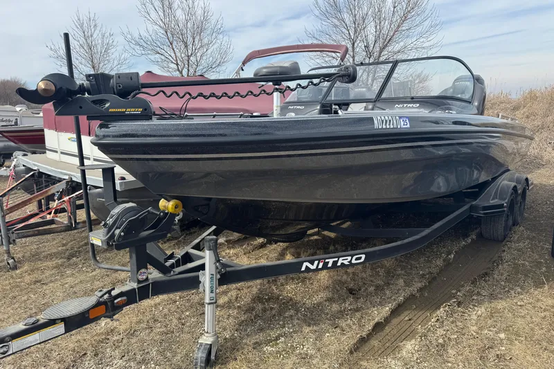 The Image of 2018 Nitro ZV21 boat on trailer, parked outdoors, featuring Minn Kota trolling motor. - 1