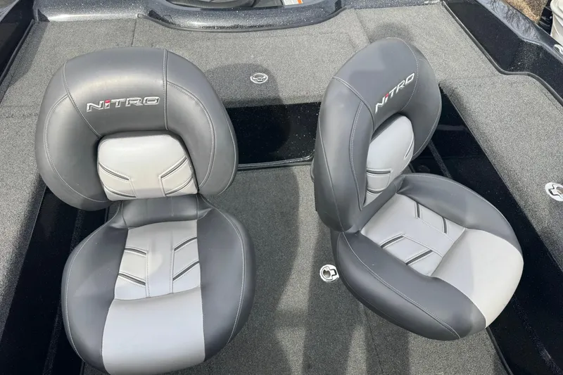 Slide: The Image of Two gray Nitro ZV21 boat seats, 2018 model, on a carpeted deck. - 11