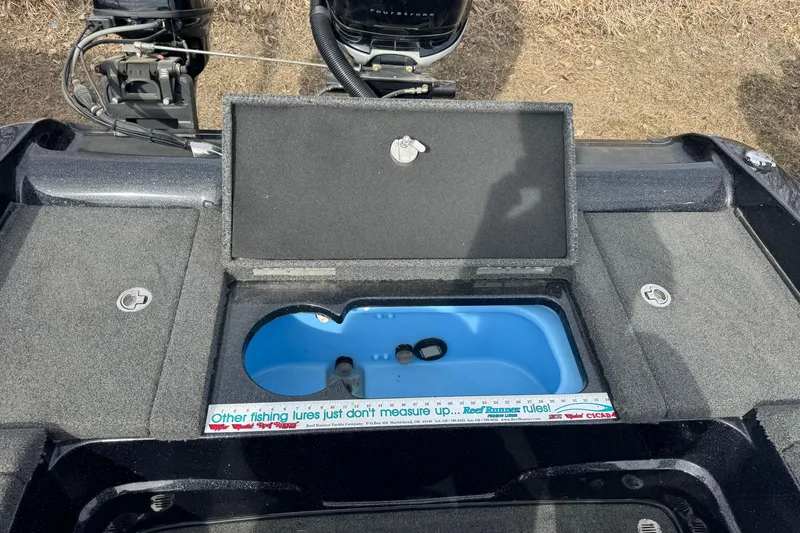 Slide: The Image of Open storage compartment on a 2018 Nitro ZV21 boat with blue interior. - 12