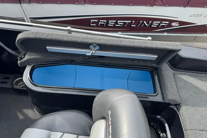 Slide: The Image of Open storage compartment in a 2018 Nitro ZV21 boat, with blue interior. - 13