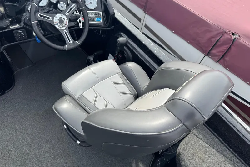 Slide: The Image of 2018 Nitro ZV21 boat interior with steering wheel and cushioned seat. - 6